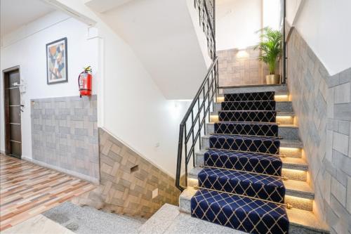 a staircase in a house with blue stair risers at FabExpress Sunset Residency - Nr Apollo Hospitals in Mumbai