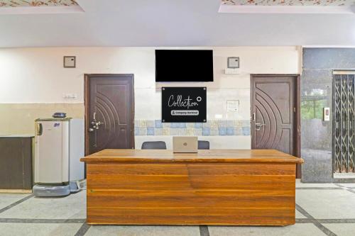 a reception desk with a laptop on top of it at Super Collection O Gachibowli in Hyderabad