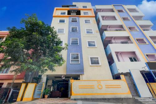 a tall building with a gate in front of it at Super Collection O Gachibowli in Hyderabad