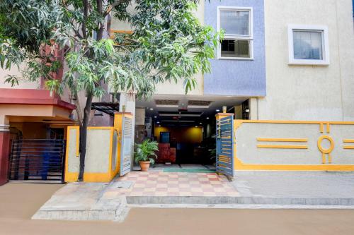 an entrance to a building with a gate and trees at Super Collection O Gachibowli in Hyderabad