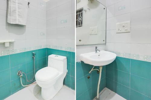 a bathroom with a toilet and a sink at Super Townhouse Madiwala Lake Park in Bengaluru