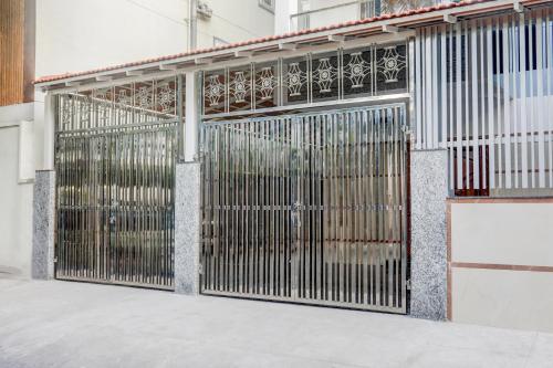 a metal gate in front of a building at Super Townhouse Madiwala Lake Park in Bengaluru