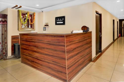 a wood paneled bar in a room with at Super Hotel O Benz Circle Crossway Vijayawada Formerly Akshaya Elite in Vijayawada