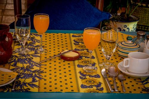 a table with three glasses of orange juice on a table at Hotel Los Castaños in Cartajima