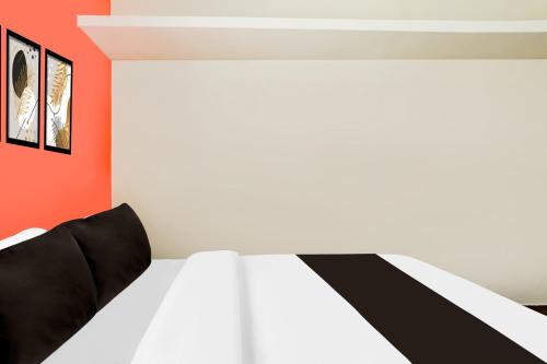 a bedroom with a black and white bed at Collection O DLF IT Park Ramapuram in Chennai