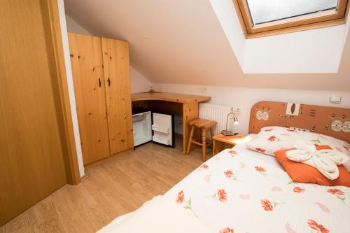 a bedroom with a bed and a desk at Accommodation Resman in Bohinj