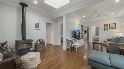 a living room with a couch and a fireplace at Diamond Escape - Pearl in Umina
