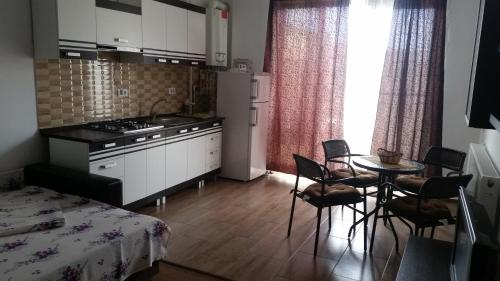 a small kitchen with a table and chairs in a room at Apartament la mare Mamaia Nord in Mamaia Nord
