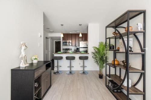 a kitchen with a counter and stools in a room at Modern Condo in Downtown Vancouver in Vancouver