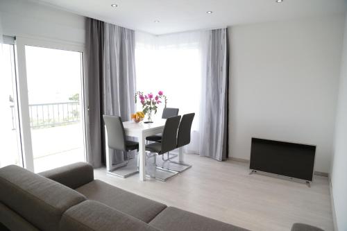 a living room with a couch and a table with chairs at Apartment Nada in Tučepi