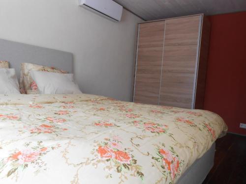 a bedroom with a large bed with a floral bedspread at Yellow Center Holiday Home in Pärnu