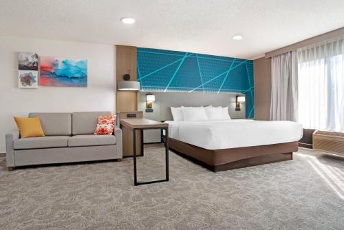 a hotel room with a bed and a couch at Comfort Inn Livingston in Livingston