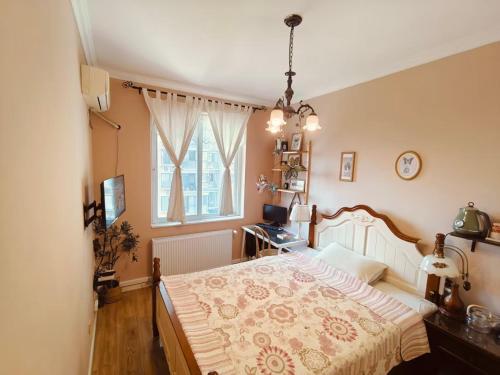 a bedroom with a large bed and a window at koko's garden and cats --4mins walk from jingjusi metro st ation, English-speaking service in Chengdu
