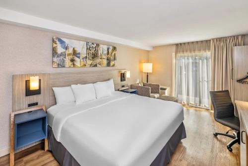 a large white bed in a hotel room at Comfort Inn in Fredericton