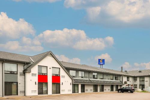 a building with a car parked in a parking lot at Comfort Inn in Corner Brook