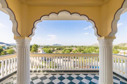 a balcony with a view of the mountains at Umrao Mahal Jaipur in Jaipur