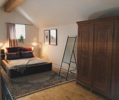 a bedroom with a bed and a dresser and a ladder at Ferienwohnung auf dem Bauernhof 