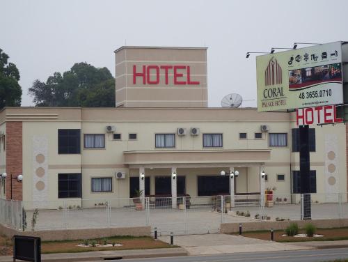 a hotel with a sign on top of it at Coral Palace Hotel in Sangão