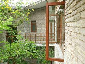 a mirror on the side of a brick building at Mum's Garden Resort in Pokhara