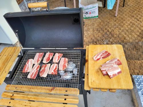 a grill with a bunch of meat on it at U&i펜션 in Yangyang