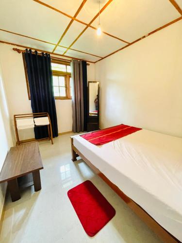 a bedroom with a bed and a bench in it at New Forest Glen Nest in Ella