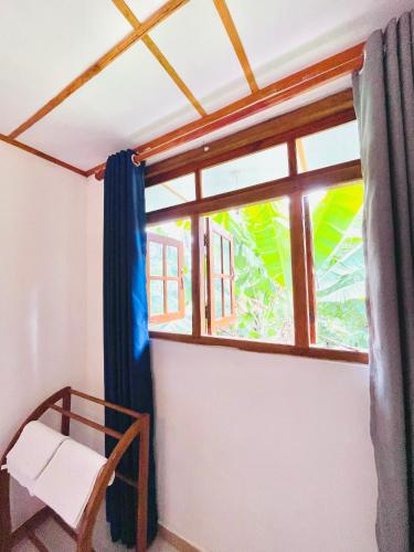 a room with a window and a chair at New Forest Glen Nest in Ella