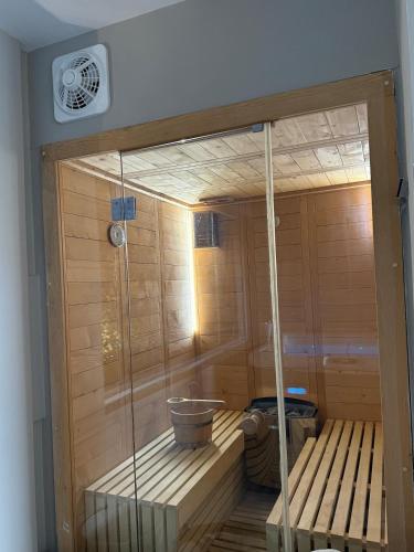 a sauna with a wooden floor and a tub at Aqua Bliss Piraeus in Piraeus