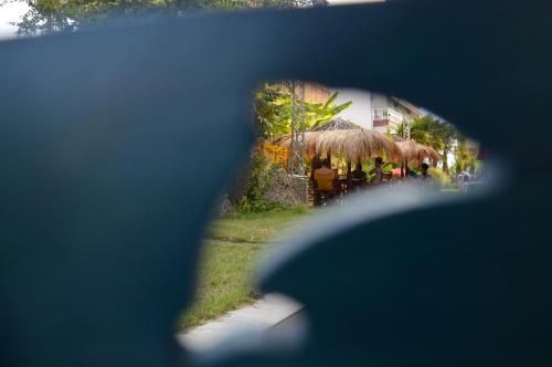 a view of a person looking at a restaurant through a window at Lilalo Ηotel in Paralia Katerinis