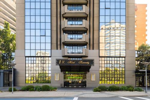 a building with a sign on the front of it at Wyndham Garden Santiago Kennedy in Santiago