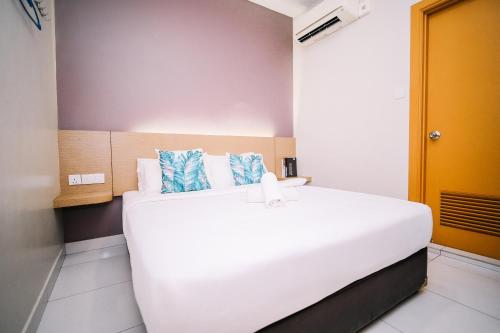 a bedroom with a large white bed in a room at Swing & Pillows - Sky Star, KLIA 1 KLIA 2, Sepang in Sepang