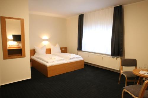 a hotel room with a bed and a window at City-Pension Magdeburg in Magdeburg
