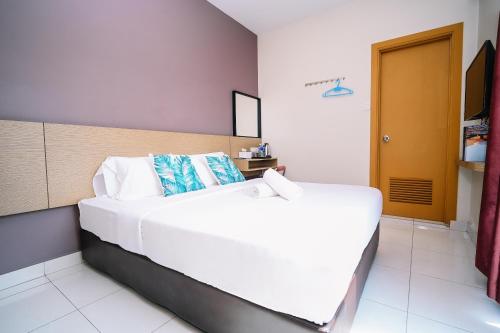 a bedroom with a large white bed in a room at Swing & Pillows - Sky Star, KLIA 1 KLIA 2, Sepang in Sepang