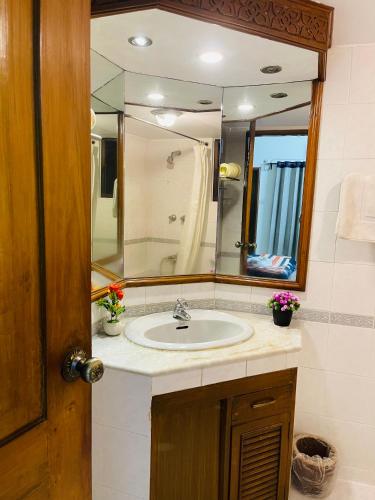 a bathroom with a sink and a mirror at Gulshan Elegant Center 3 BR AC Flat Near Cafes & Shops Heart of Gulshan in Dhaka
