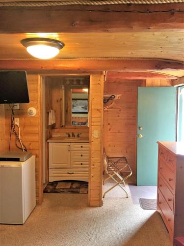 a bathroom in a log cabin with a sink at Z Bar Motel in Buffalo