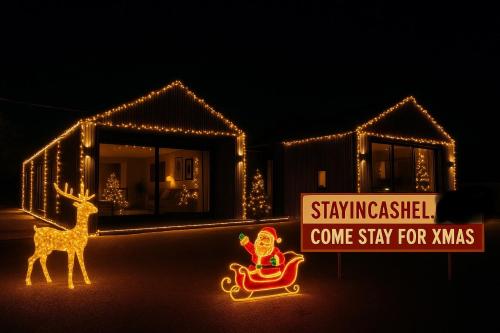 a house decorated with christmas lights and a santa clause at Deerpark semi sleeps 8 with sofa bed & optional extra outdoor sauna in Cashel