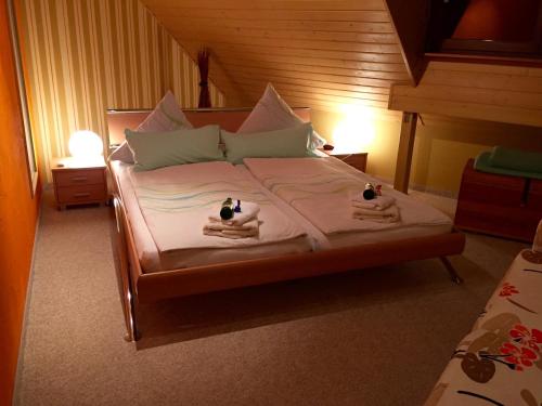 a bedroom with a bed with two towels on it at Ferienwohnung Tina in Pirna
