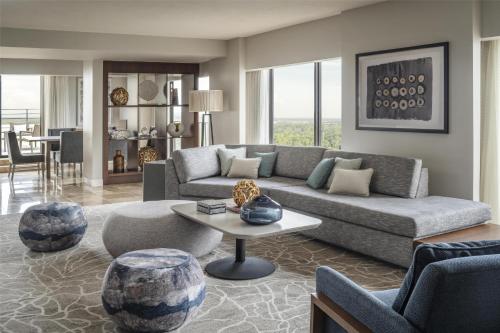 a living room with a couch and a table at Hyatt Regency Grand Cypress Resort - Free Shuttle to Theme Parks! in Orlando