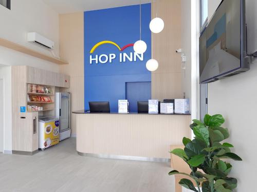 a hop inn sign on the wall of a store at HOP INN Kamphaeng Phet in Kamphaeng Phet