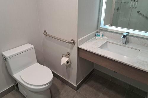 a bathroom with a white toilet and a sink at Comfort Hotel Vancouver Airport in Richmond