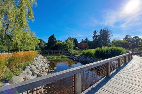 a wooden bridge over a river with rocks and trees at Comfort Hotel Vancouver Airport in Richmond