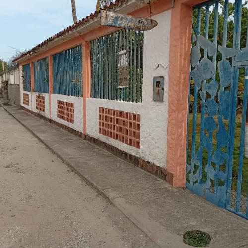 a building with a mural on the side of it at Ecoposada Quinta Le Palme in Chichiriviche