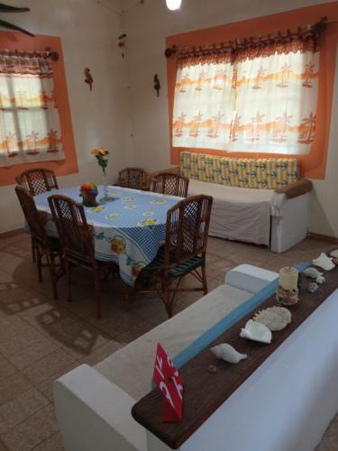 a living room with a table and chairs and a bed at Ecoposada Quinta Le Palme in Chichiriviche