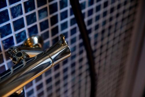 a close up of a metal railing with blue tiles at RouTe5 in Matsumoto