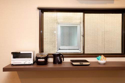 a kitchen counter with a microwave and a window at RouTe5 in Matsumoto