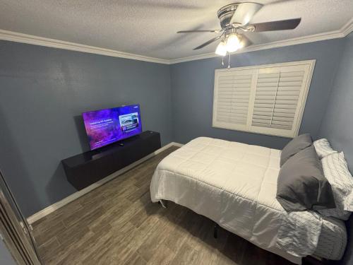 a bedroom with a bed and a flat screen tv at Riverside Views & Pool Retreat in Riverside