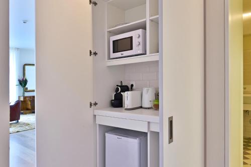 a small kitchen with a microwave and a counter at Casa Balthazar in Lisbon
