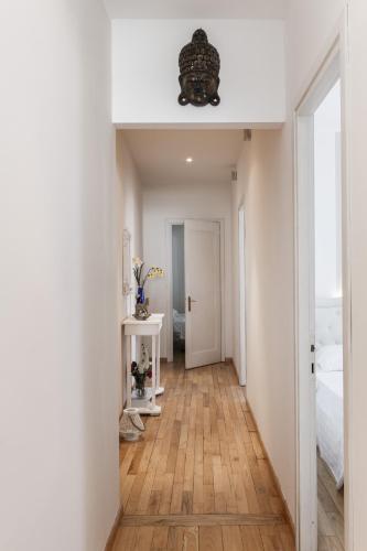 a hallway with white walls and a wooden floor at Domus Karalis in Cagliari
