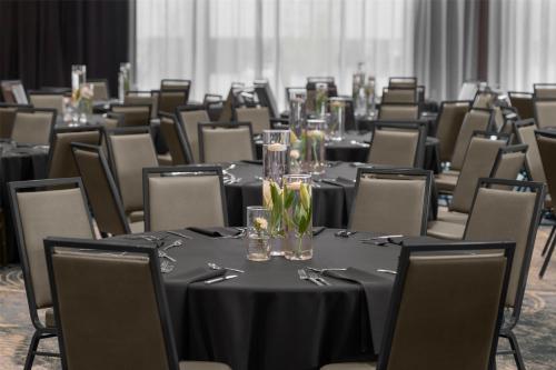 a set of tables in a room with chairs at Homewood Suites By Hilton Grand Prairie At EpicCentral in Grand Prairie