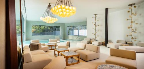 a waiting room with couches and chairs and a pool at Hyatt Regency Zadar in Zadar
