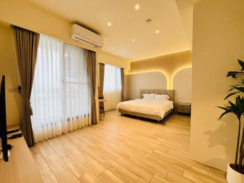 a bedroom with a bed and a large window at Mu Yue Homestay in Dongshan